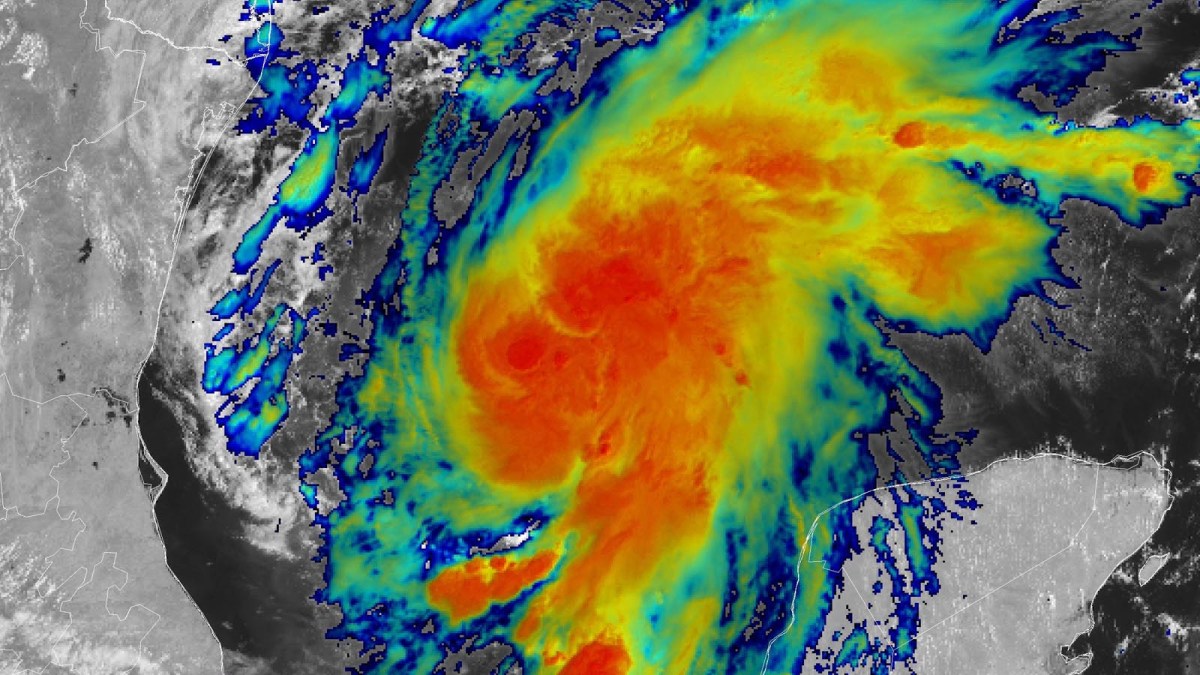 Colourised satellite composite of Tropical Storm Isaias over the Gulf of Mexico, with red and orange bands showing deep convection around the storm centre